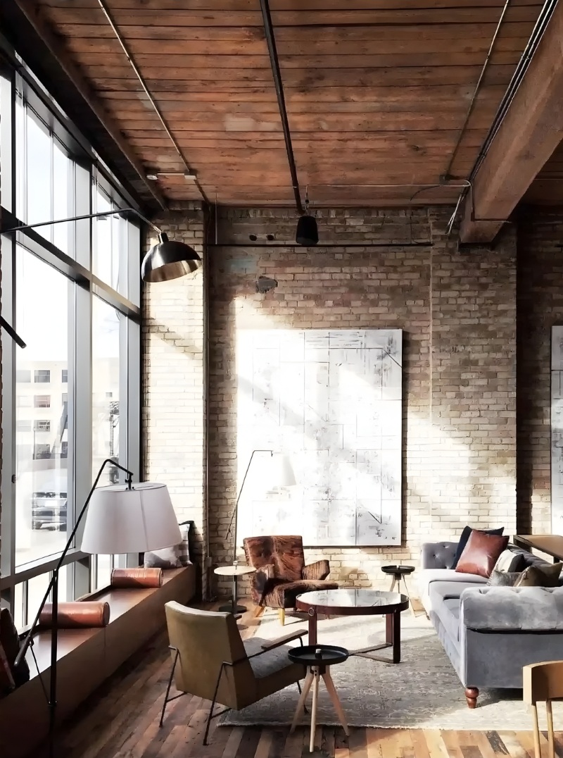 Phong cách Industrial: Khi những đường nét thô ráp kể câu chuyện kiến trúc giàu chất thơ | Flexdecor VN | 2 Không gian nội thất phong cách Industrial với tường gạch thô, trần gỗ để lộ kết cấu và ánh sáng tự nhiên lớn